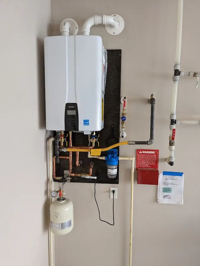 Professional plumber installing copper piping in a Fair Haven home